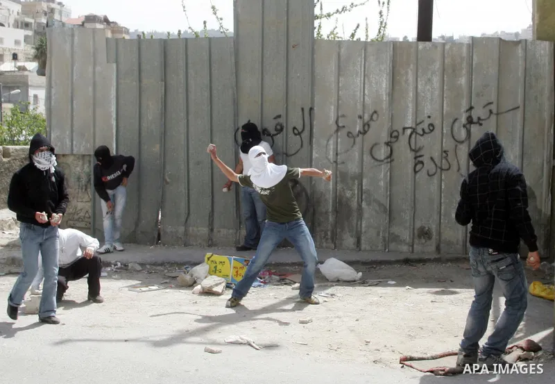 Palestinian youths hurl stones towards Israeli border police during clashes in the mostly Arab neighborhood of Silwan in East Jerusalem April 08, 2011. Photo by Mahfouz Abu Turk .