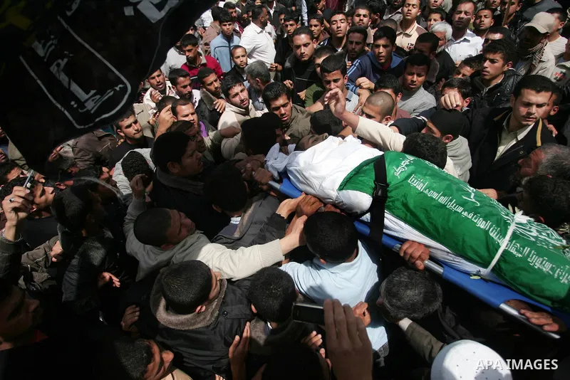 Palestinians carry the body of Hamas militant Abdallah Al Qarra during his funeral in Khan Younis, southern Gaza Strip, Friday, April 8, 2011. Israeli aircraft and ground forces struck Gaza on Friday in a surge of deadly...