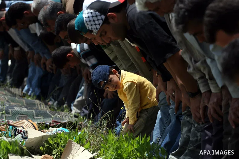 Palestinian protestors attend Friday prayers during the weekly demonstration against Israel's separation barrier in the West Bank village of Nilin, near Ramallah, Friday, April 8, 2011. Israel says the barrier is necessa...