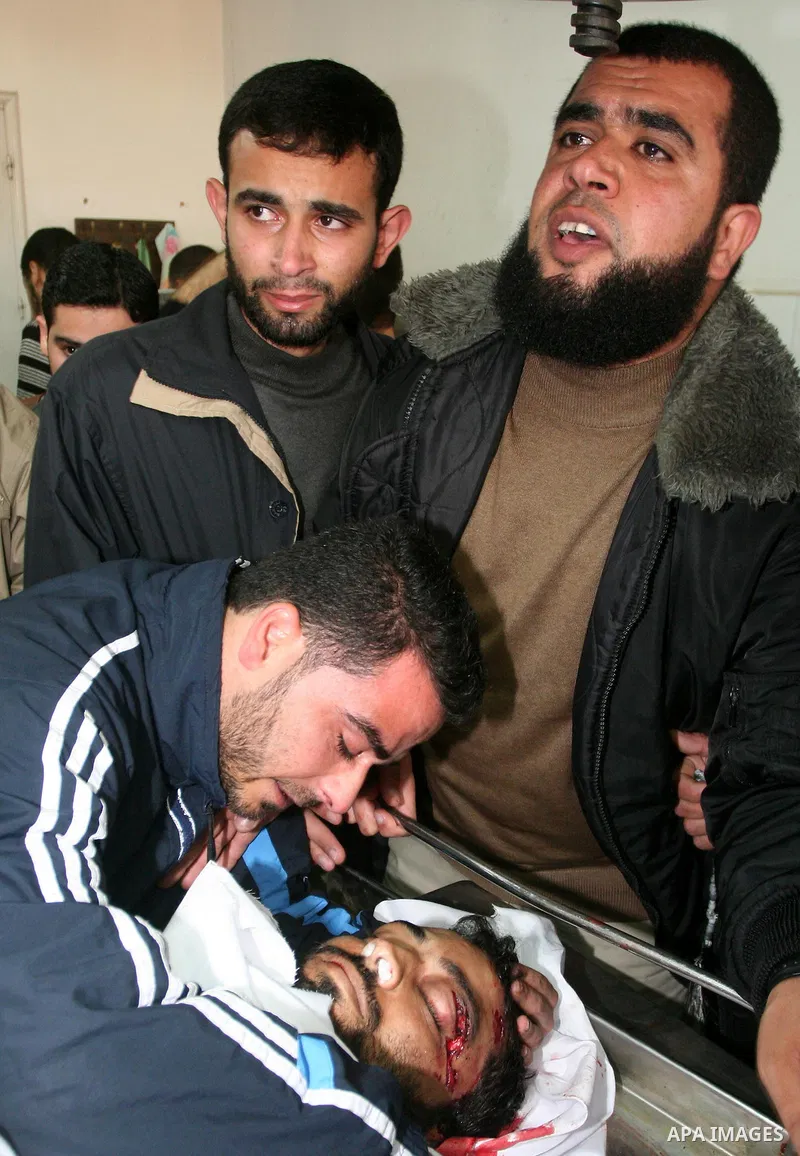 Palestinian relatives of the militant Raed Shehada weep in a hospital in Gaza City on April 8, 2011 after he was killed in an Israeli air strike on northern Gaza, a spokesman for the Palestinian emergency services. Photo...