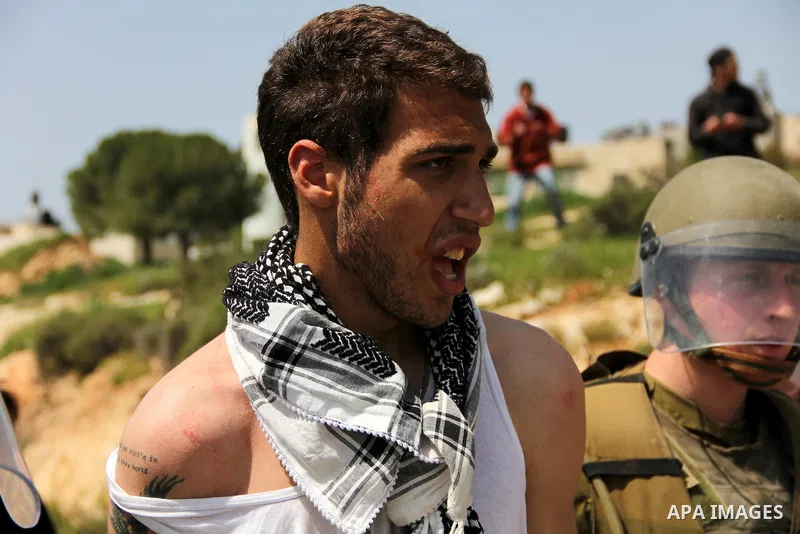 Israeli soldiers detain a protester during the weekly demonstration against Israel's separation barrier in the West Bank village of Nabi Saleh, near Ramallah, Friday, April 8, 2011. Israel says the barrier is necessary f...