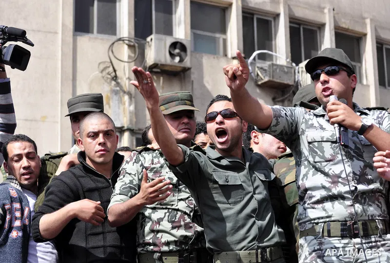 Egyptian officers take part in a protest calling the Field Marshal Hussein Tantawi to step down in Cairo's central Tahrir Square, the focal point of Egyptian uprising, during a protest demanding prosecution of Mubarak an...
