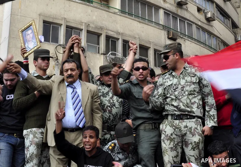 Egyptian officers take part in a protest calling the Field Marshal Hussein Tantawi to step down in Cairo's central Tahrir Square, the focal point of Egyptian uprising, during a protest demanding prosecution of Mubarak an...