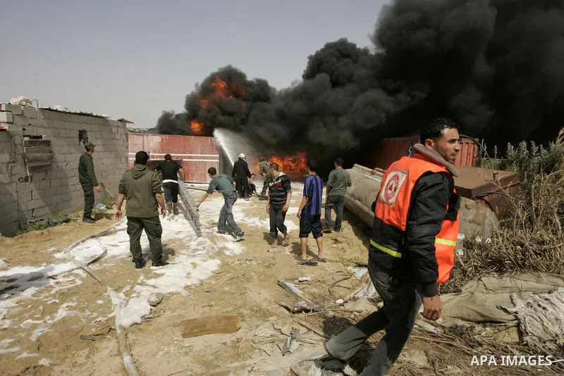 Palestinians try to extinguish an accidental fire that swept over a smuggling tunnel in the southern Gaza Strip town of Rafah on the border with Egypt on April 8, 2011. Tunnels under the town of Rafah that straddles the...