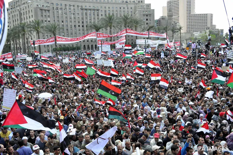 Egyptians hold flags and shout slogans as tens of thousands gathered for a demonstration at Cairo's Tahrir Square on April 8, 2011, two months after president Hosni Mubarak was ousted, to demand that former regime offici...