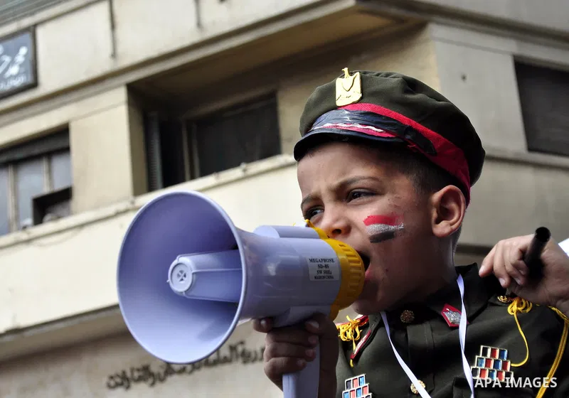 Egyptians hold flags and shout slogans as tens of thousands gathered for a demonstration at Cairo's Tahrir Square on April 8, 2011, two months after president Hosni Mubarak was ousted, to demand that former regime offici...