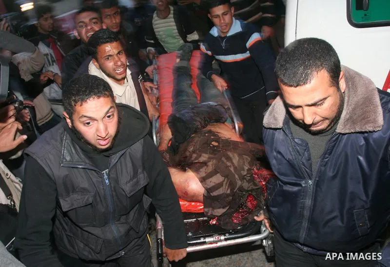 Medics wheel a wounded Palestinian youth into a hospital in Gaza City on April 8, 2011 following Israeli shelling in which two Palestinians were killed and 10 people wounded, including some children. Photo by Mohammed As...