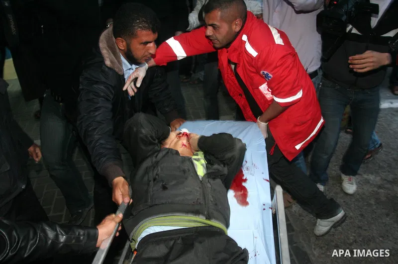 Medics wheel a wounded Palestinian youth into a hospital in Gaza City on April 8, 2011 following Israeli shelling in which two Palestinians were killed and 10 people wounded, including some children. Photo by Mohammed As...