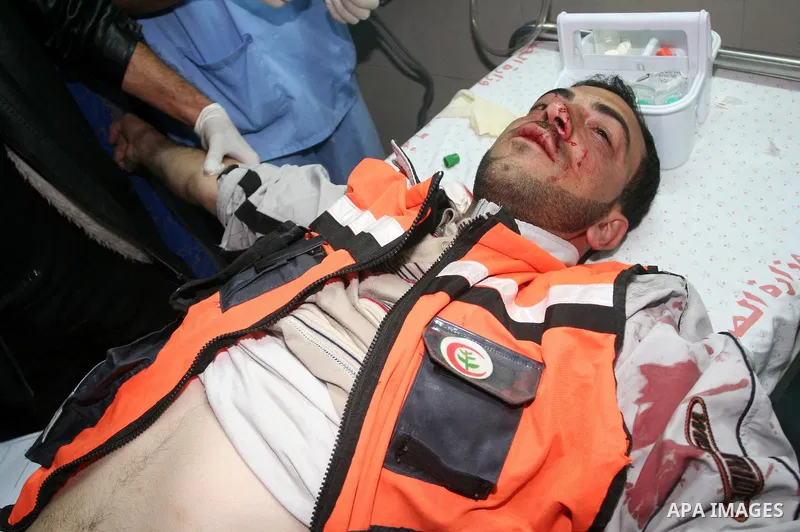 Medics rush a wounded Palestinian man into a hospital in Gaza City on April 8, 2011 following Israeli shelling in which two Palestinians were killed and 10 people wounded, including some children. Photo by Mohammed Asad