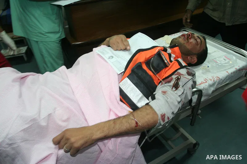 Medics rush a wounded Palestinian man into a hospital in Gaza City on April 8, 2011 following Israeli shelling in which two Palestinians were killed and 10 people wounded, including some children. Photo by Mohammed Asad