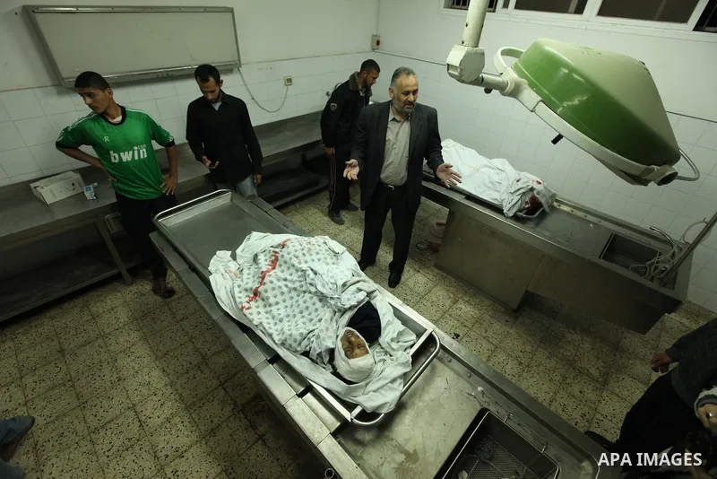 The body of Palestinian boy Mahmoud Al-Jarowsha lies at the morgue of Shifa Hospital after Israeli air strikes in Gaza City April 8, 2011. Israeli air strikes and shelling killed nine Palestinians in the Gaza Strip on Fr...