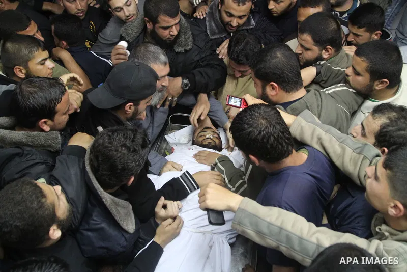 Palestinians carry the body of Hamas militant Rayed Shehada during his funeral in Shati refugee camp in Gaza City on 08 April 2011 The air raids came a day after Gaza-based militants fired an attack-tank shell at an Isra...