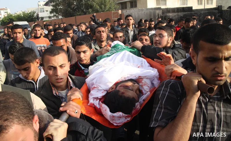 Palestinians carry the body of Hamas militant Rayed Shehada during his funeral in Shati refugee camp in Gaza City on 08 April 2011 The air raids came a day after Gaza-based militants fired an attack-tank shell at an Isra...