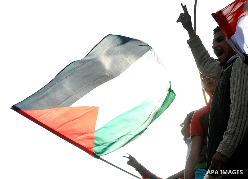 Egyptian protesters wave Palestinian flags as they gather outside the Israeli embassy in Cairo on April 8, 2011 to protest against the Israeli strikes on the neighbouring Gaza Strip, which have killed 16 people in the pa...