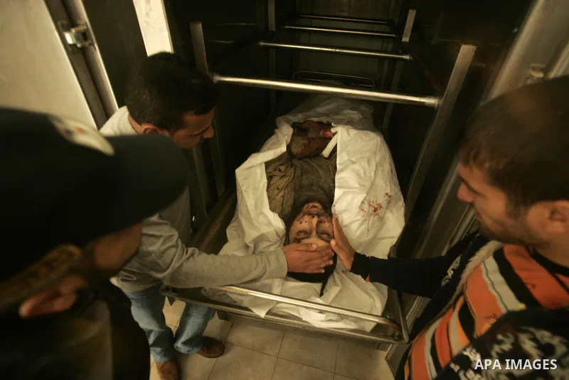 Palestinians pray over the body of the commander of the Islamic Hamas militant Tayser Abu Snima, 29, at the treatment room of Al Najar hospital following an Israeli air strikes on Hamas militants group in Rafah, southern...