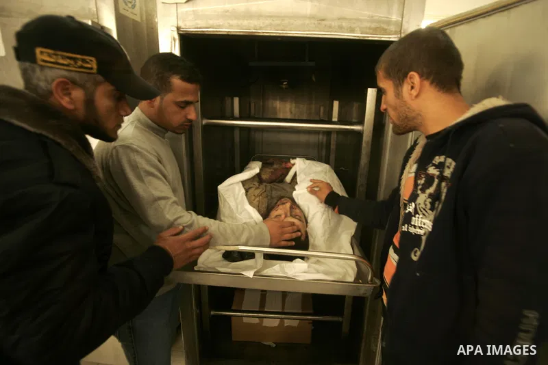 Palestinians pray over the body of the commander of the Islamic Hamas militant Tayser Abu Snima, 29, at the treatment room of Al Najar hospital following an Israeli air strikes on Hamas militants group in Rafah, southern...