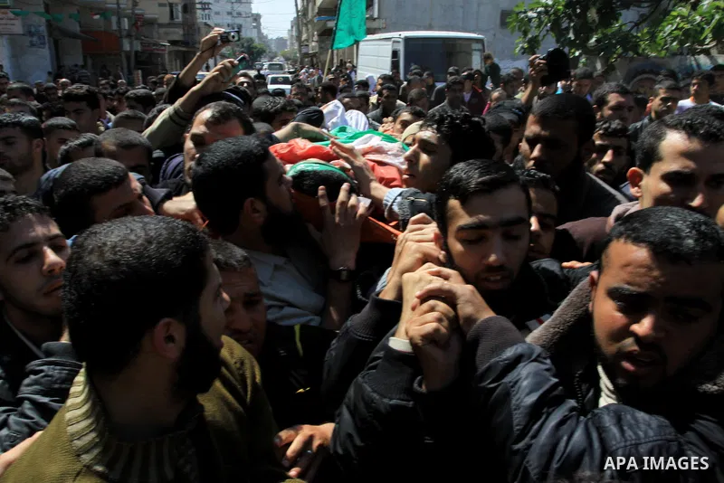 Mourners carry the body of Hamas militant Ahmed Zaitonia during his funeral in Gaza City, April 9, 2011. as the Israeli army pounded the Gaza Strip, killing at least 12 people as militants fired dozens of mortar rounds a...