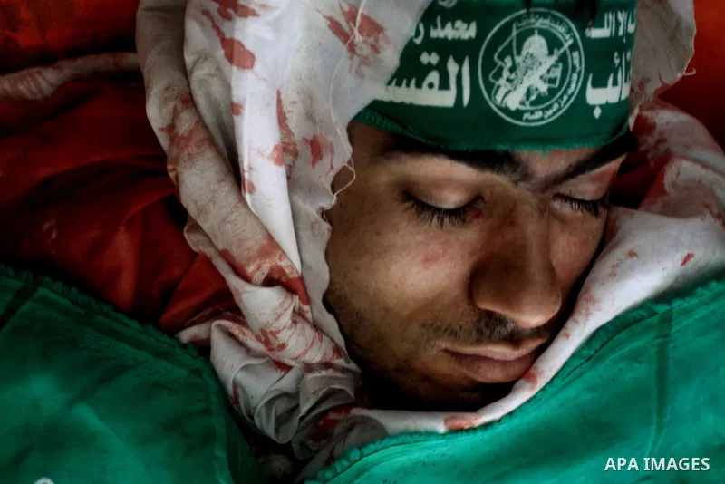 Palestinians pray next to the body of Hamas militant Ahmed Zaitonia during his funeral in Gaza City, April 9, 2011. as the Israeli army pounded the Gaza Strip, killing at least 12 people as militants fired dozens of mort...