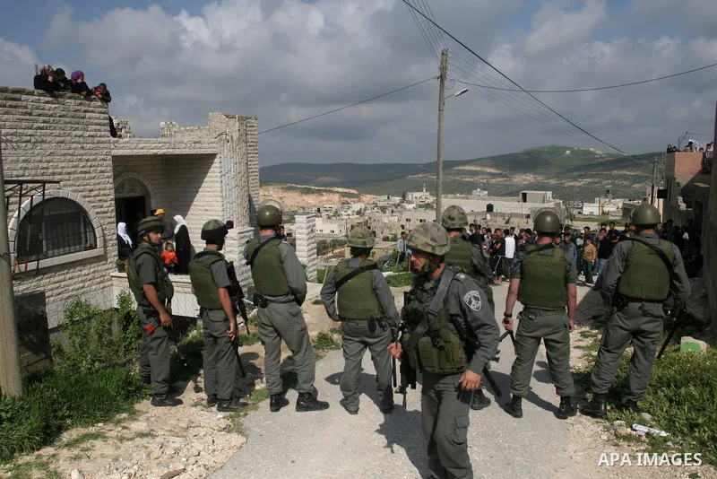 Israeli troops arrive to break up a scuffle between Jewish settlers and Palestinians in the West Bank village of Aseera, Saturday, April 9, 2011. Palestinian witnesses said about 40 settlers entered the village and scuff...