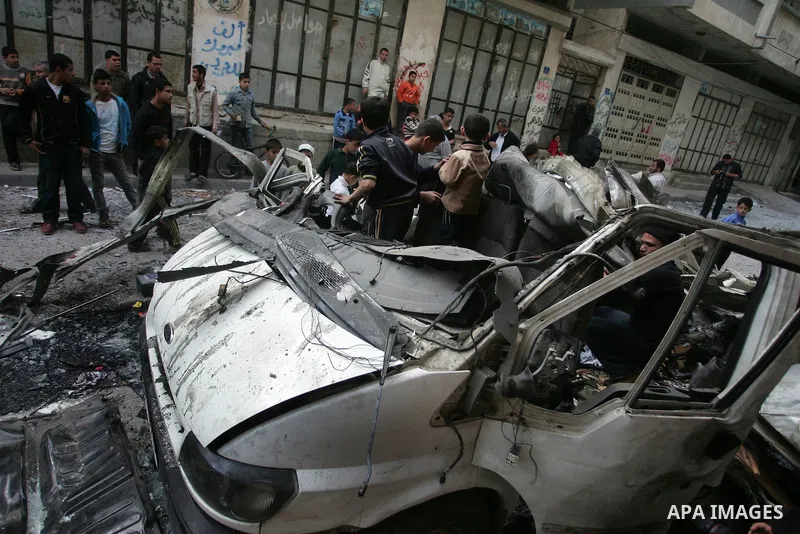 Palestinians inspect the damage to a vehicle after an Israeli air strike in Gaza City April 9, 2011. Israel killed four Palestinian militants and wounded half a dozen others as it pursued air raids in Gaza for a third da...