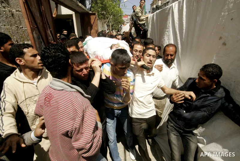 Palestinian mourners carry the body of Hamas militant Mohammed Awaja during his funeral in Rafah in the southern Gaza Strip on April 9, 2011 as the Israeli army pounded the Gaza Strip, killing at least 12 people while mi...