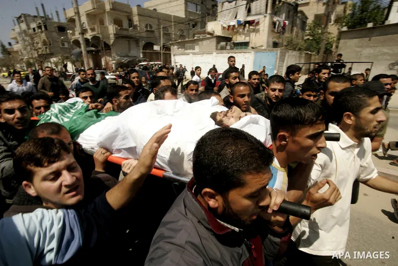 Palestinian mourners carry the body of Hamas militant Mohammed Awaja during his funeral in Rafah in the southern Gaza Strip on April 9, 2011 as the Israeli army pounded the Gaza Strip, killing at least 12 people while mi...