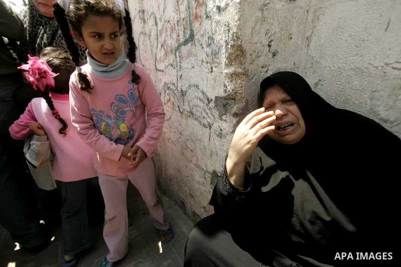 A Palestinian woman mourn at the body of Hamas militant Mohammed Awaja during his funeral in Rafah in the southern Gaza Strip on April 9, 2011 as the Israeli army pounded the Gaza Strip, killing at least 12 people while...