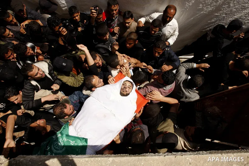Palestinian mourners carry the body of Hamas militant Mohammed Awaja during his funeral in Rafah in the southern Gaza Strip on April 9, 2011 as the Israeli army pounded the Gaza Strip, killing at least 12 people while mi...