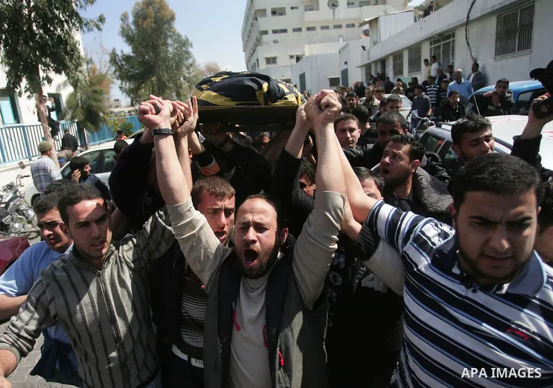 Palestinian mourners carry the body of Islamic Jihad militant Ahmad Al Ar'eer, killed in an Israeli airstrike, during his funeral in the east of Gaza City on 09 April 2011. Al Ar'eer was killed the previous day with othe...