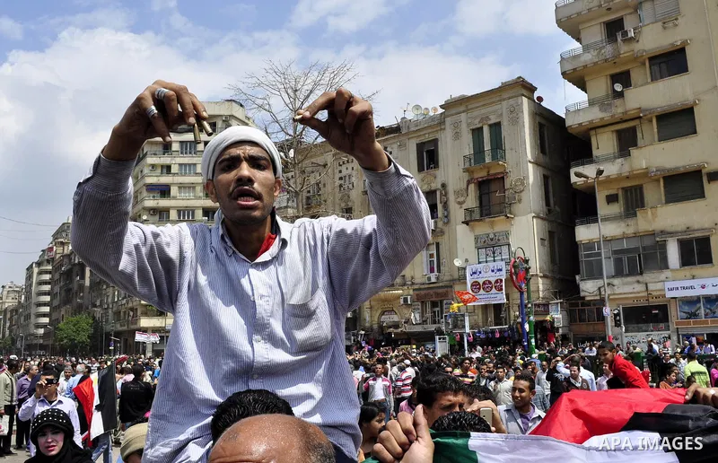 Protesters chant slogans as they march following an attack by security forces in Tahrir Square, in Cairo, Egypt, Saturday, April 9, 2011. Demonstrators burned cars and barricaded themselves with barbed wire inside a cent...