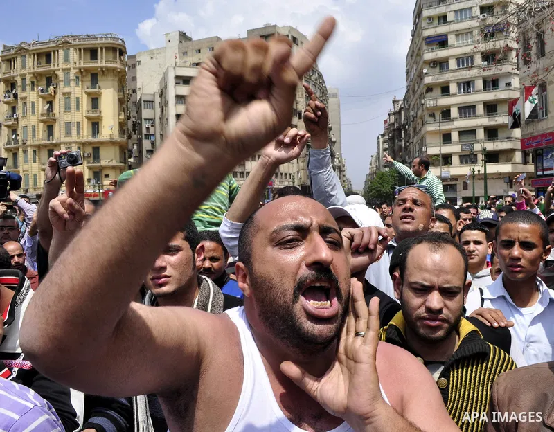 Protesters chant slogans as they march following an attack by security forces in Tahrir Square, in Cairo, Egypt, Saturday, April 9, 2011. Demonstrators burned cars and barricaded themselves with barbed wire inside a cent...