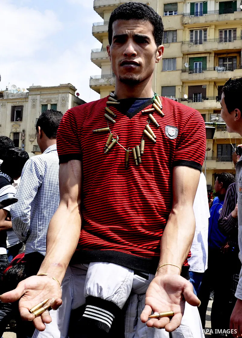 Protesters chant slogans as they march following an attack by security forces in Tahrir Square, in Cairo, Egypt, Saturday, April 9, 2011. Demonstrators burned cars and barricaded themselves with barbed wire inside a cent...