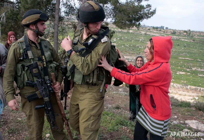 A Palestinian demonstrator argues with an Israeli soldier during a protest against Israel's controversial separation barrier organized by Palestinian and foreign peace activists in the West Bank village of Safa, near Heb...