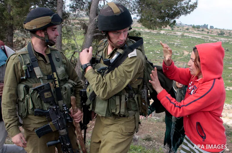 A Palestinian demonstrator argues with an Israeli soldier during a protest against Israel's controversial separation barrier organized by Palestinian and foreign peace activists in the West Bank village of Safa, near Heb...