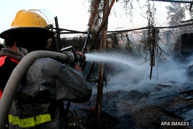 Members of civil defence try to stop fire in a Hut after an Israeli air strike in gaza city. as the Israeli army pounded the Gaza Strip, killing at least 12 people as militants fired dozens of mortar rounds and rockets i...