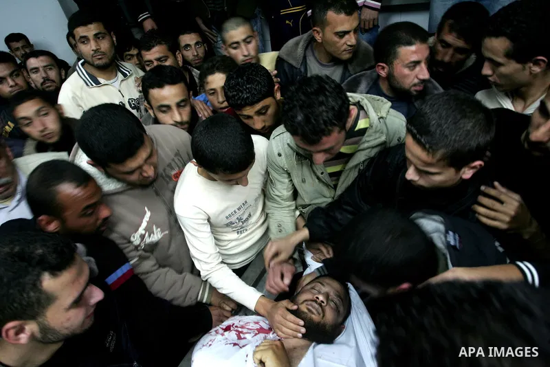 Palestinian relatives gather around the body of Raed El-Bor at the morgue of AL-shifa hospital in gaza city, April 9, 2011.The Israeli army pounded the Gaza Strip, killing at least 12 people while militants fired dozens...