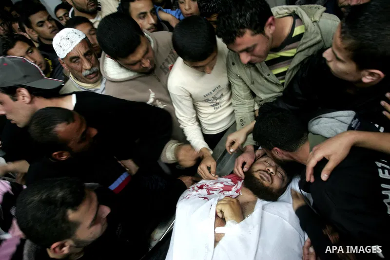 Palestinian relatives gather around the body of Raed El-Bor at the morgue of AL-shifa hospital in gaza city, April 9, 2011.The Israeli army pounded the Gaza Strip, killing at least 12 people while militants fired dozens...