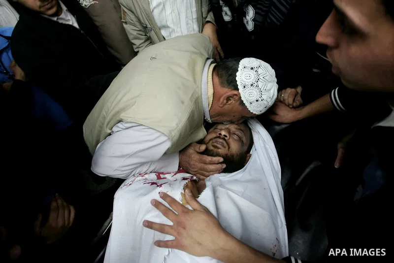 Palestinian relatives gather around the body of Raed El-Bor at the morgue of AL-shifa hospital in gaza city, April 9, 2011.The Israeli army pounded the Gaza Strip, killing at least 12 people while militants fired dozens...
