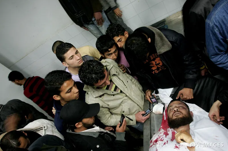 Palestinian relatives gather around the body of Raed El-Bor at the morgue of AL-shifa hospital in gaza city, April 9, 2011.The Israeli army pounded the Gaza Strip, killing at least 12 people while militants fired dozens...
