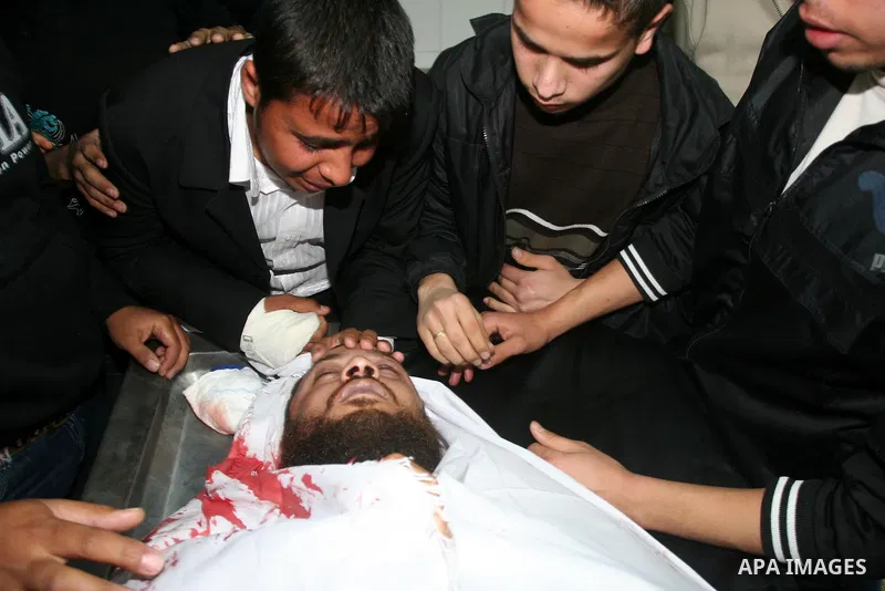 Palestinian relatives gather around the body of Raed El-Bor at the morgue of AL-shifa hospital in Gaza city, April 9, 2011.The Israeli army pounded the Gaza Strip, killing at least 18 people while militants fired dozens...