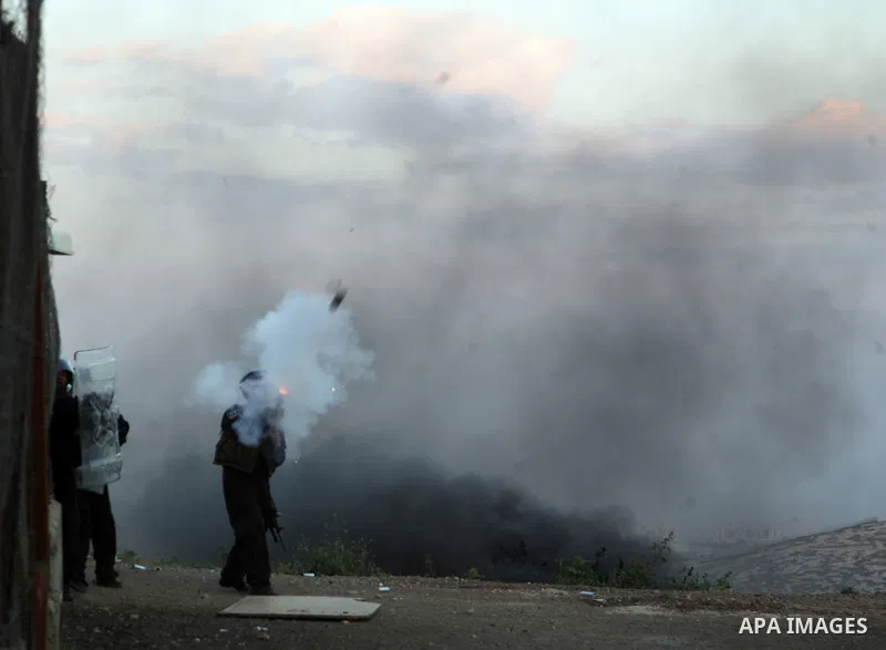 Israeli soldiers fire tear gas canisters towards Palestinian youths during clashes in the most Arab neighbourhood of Issawiah in Jerusalem on April 9,2011. Photo by Mahfouz Abu Turk