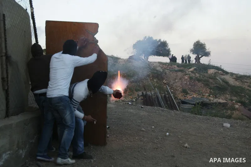 Palestinian youths hurl stones towards Israeli soldiers during clashes in the most Arab neighbourhood of Issawiah in Jerusalem on April 9,2011. Photo by Mahfouz Abu Turk