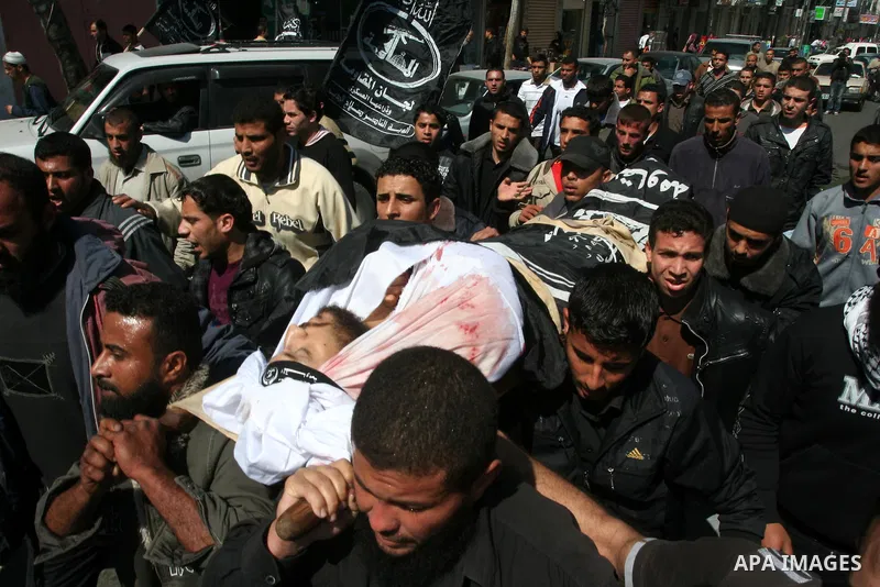 Palestinians carry the body of Popular Resistance Committees militant Raed Al-Bar during his funeral in Gaza City April 10, 2011. Al-Bar was killed in an Israeli air strike on Saturday. Palestinian militant groups in the...
