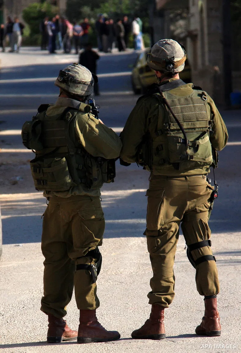 Israeli soldiers stand guard during a search operation in the village of Awarta, in the Israeli occupied northern West Bank on April 10, 2011, a day after Jewish settlers went on the rampage in two nearby Palestinian vil...