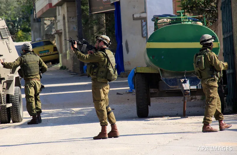 Israeli soldiers stand guard during a search operation in the village of Awarta, in the Israeli occupied northern West Bank on April 10, 2011, a day after Jewish settlers went on the rampage in two nearby Palestinian vil...