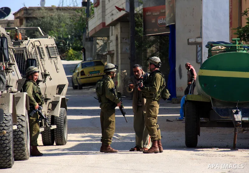 Israeli soldiers stand guard during a search operation in the village of Awarta, in the Israeli occupied northern West Bank on April 10, 2011, a day after Jewish settlers went on the rampage in two nearby Palestinian vil...