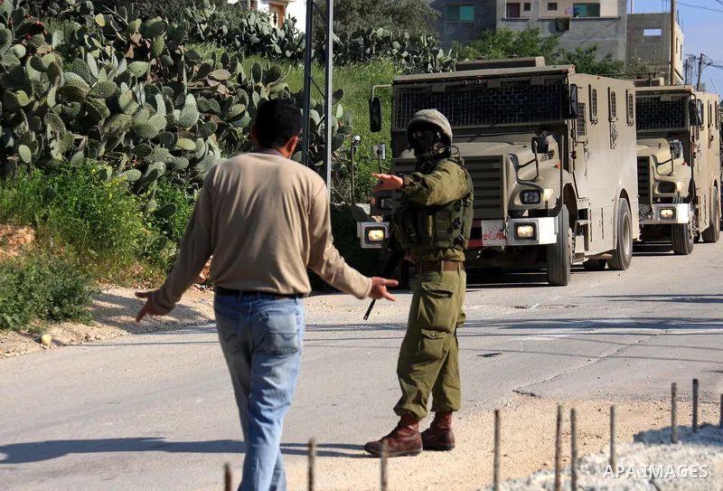 Israeli soldiers stand guard during a search operation in the village of Awarta, in the Israeli occupied northern West Bank on April 10, 2011, a day after Jewish settlers went on the rampage in two nearby Palestinian vil...