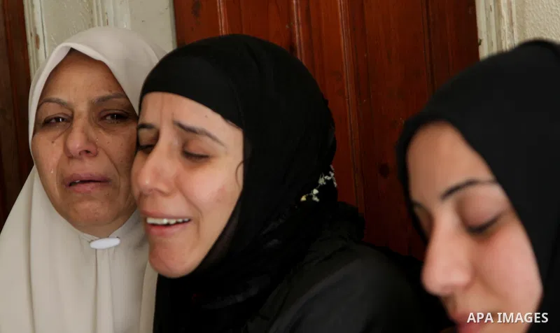 Palestinians, relatives of Popular Resistance Committees militant Raed Al-Bar, mourn during his funeral in Gaza City April 10, 2011. Al-Bar was killed in an Israeli air strike on Saturday. Palestinian militant groups in...
