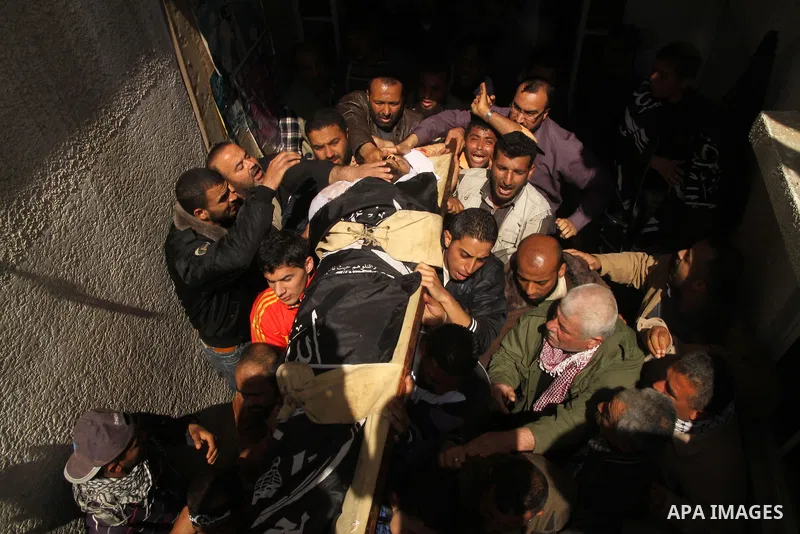 Palestinians carry the body of Popular Resistance Committees militant Raed Al-Bar during his funeral in Gaza City April 10, 2011. Al-Bar was killed in an Israeli air strike on Saturday. Palestinian militant groups in the...