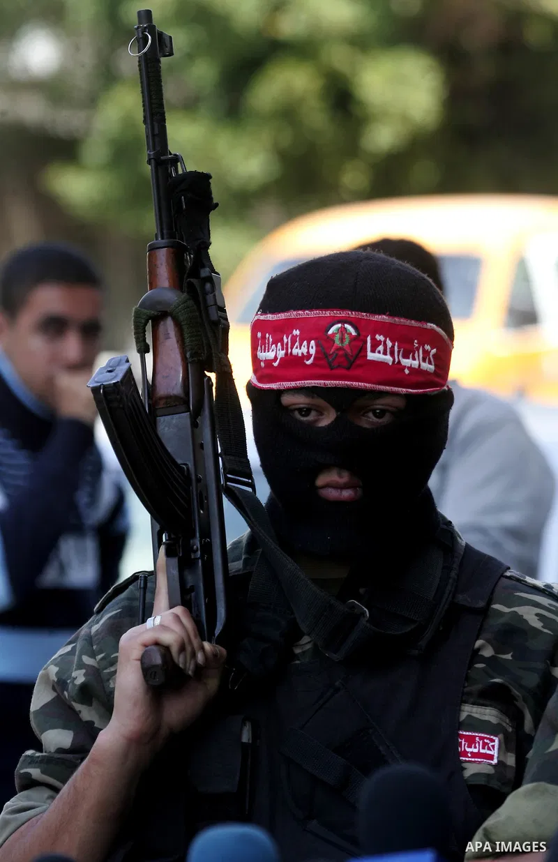 Palestinian militants of the National Resistance Brigades, the military wing of the Democratic Front for the Liberation of Palestine (DFLP), attend a news conference in the central Gaza City, 10 April 2011. Israel will c...